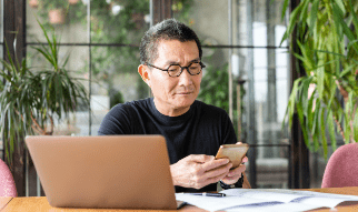 man-with-laptop-and-phone